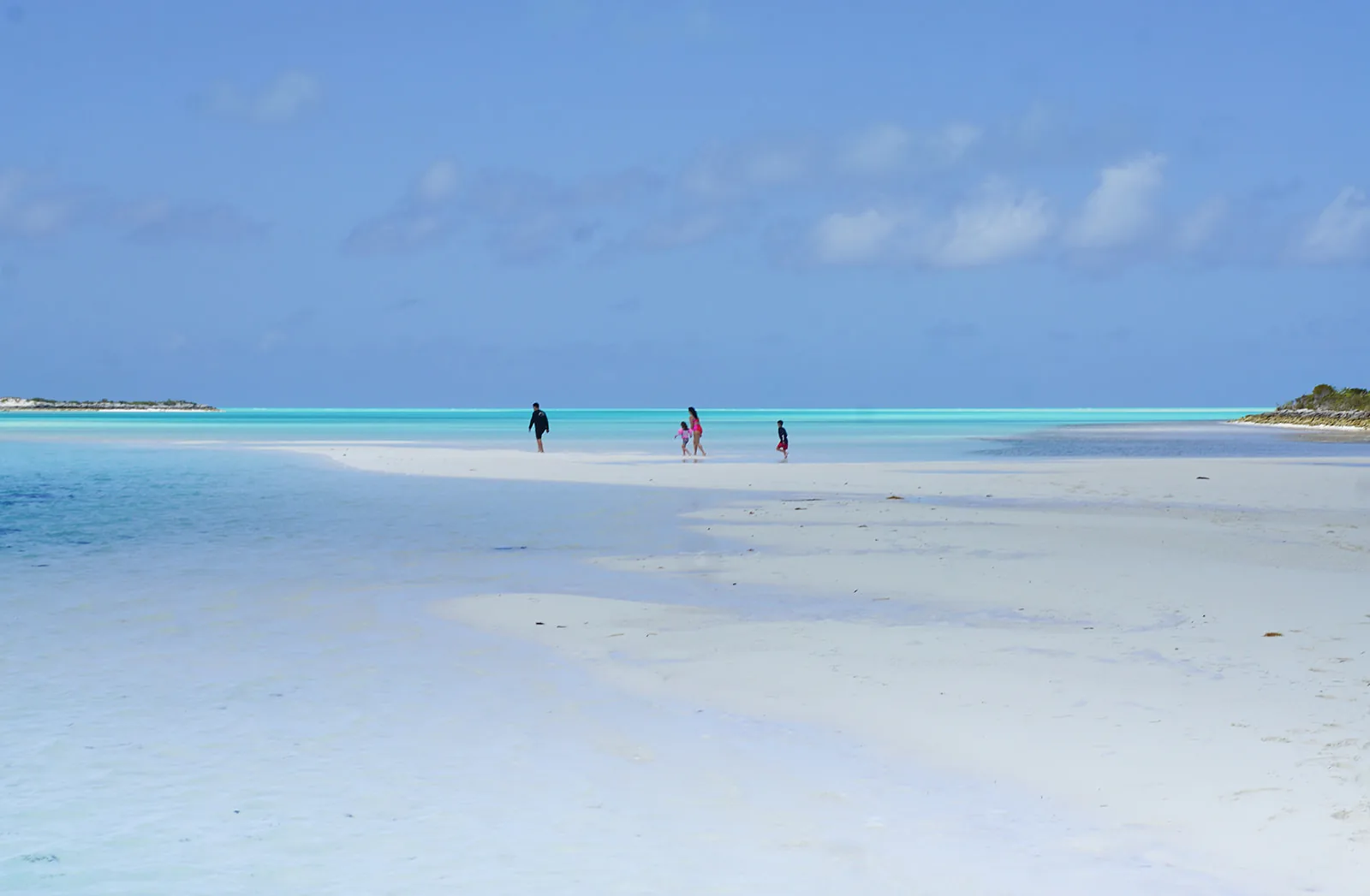 Wading out along the turquoise sandbar