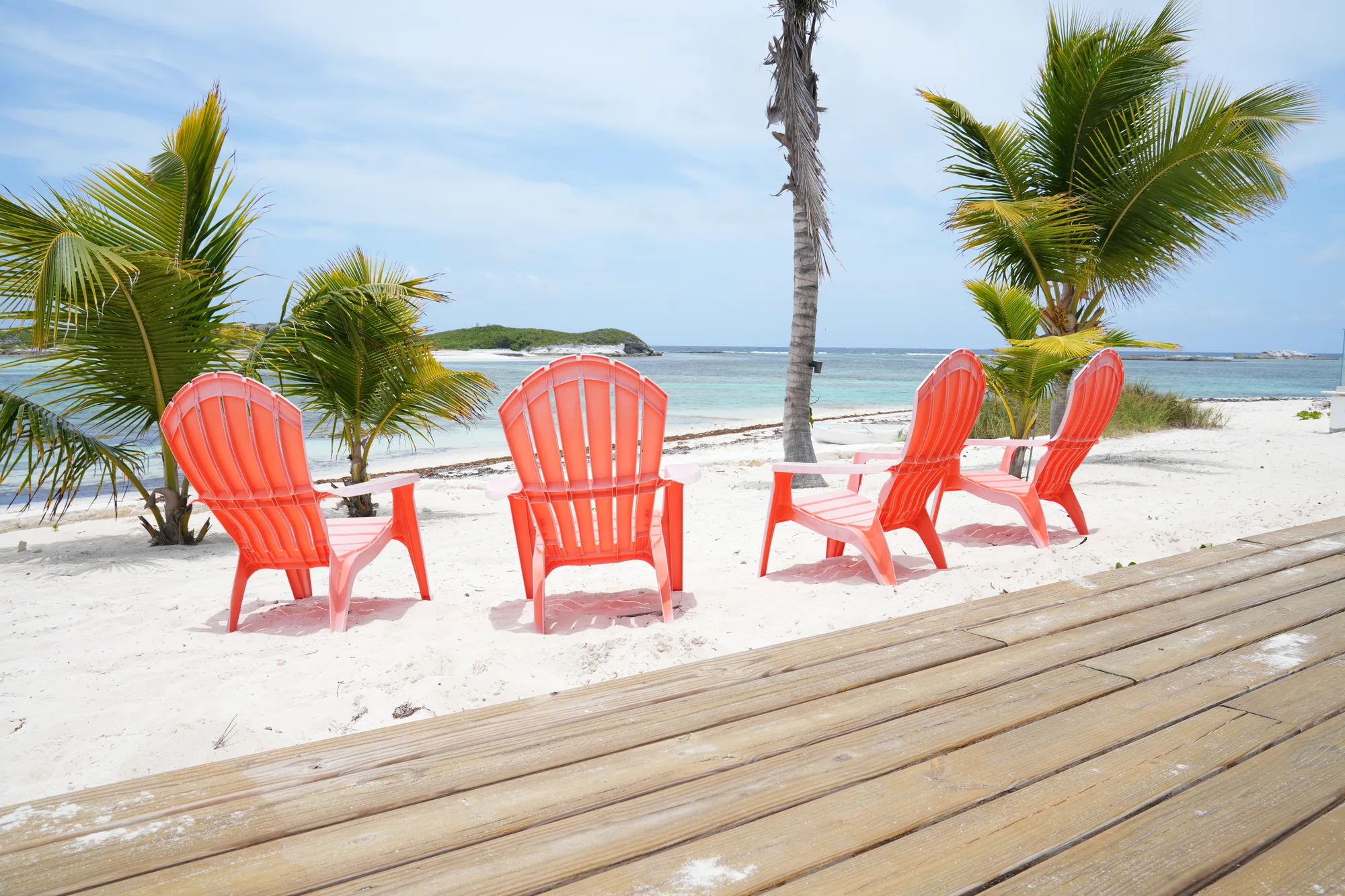 Beach chairs on the sand at Coconut Bay